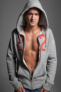 Studio Portrait Of Sexy Young Man Wearing Hooded Sweat Top