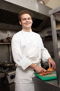Male Chef Preparing Vegetables In Restaurant Kitchen
