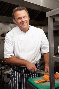 Male Chef Preparing Vegetables In Restaurant Kitchen