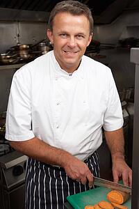 Male Chef Preparing Vegetables In Restaurant Kitchen