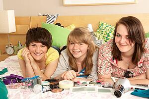 Group Of Teenage Girls In Untidy Bedroom