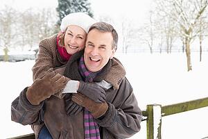 Senior Couple Standing Outside In Snowy Landscape
