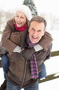 Senior Couple Standing Outside In Snowy Landscape