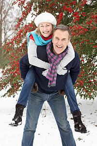 Senior Couple Outside In Snowy Landscape