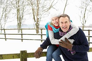 Senior Couple Standing Outside In Snowy Landscape