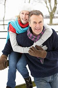 Senior Couple Standing Outside In Snowy Landscape