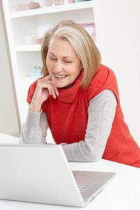 Senior Woman Using Laptop At Home