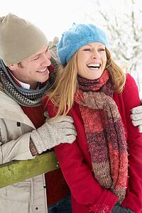 Couple Standing Outside In Snowy Landscape