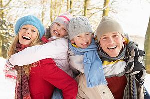 Family Having Fun Snowy Woodland