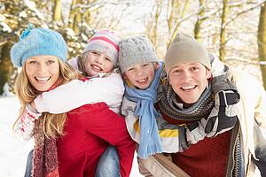 Family Having Fun Snowy Woodland