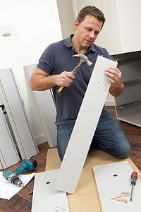 Man Assembling Flat Pack Furniture