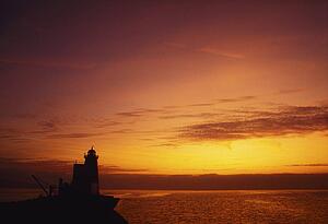 dublin, ireland; poolbeg lighthouse in dublin bay at dawn