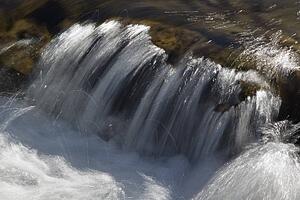 kananaskis country, alberta, canada; water streaming over rocks in the elbow river