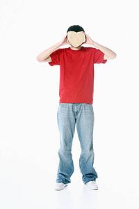 a boy with a heart covering his face