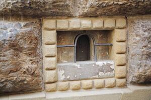 a miniature door in a stone wall