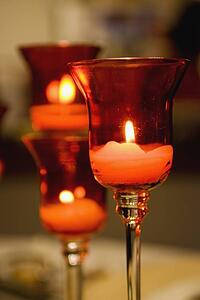 candles lit in a glass candle holder