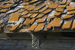 a old roof with wooden shingles needing repair