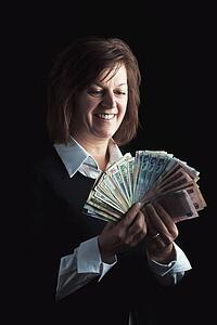 a woman fanning out dollar bills