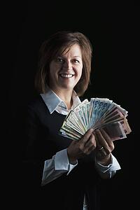 a woman fanning out dollar bills