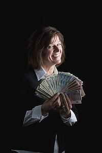 a woman fanning out dollar bills