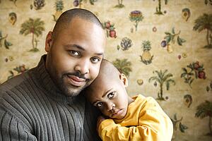 Father Smiling Holding Young Son