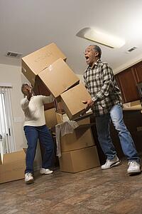 Man Dropping Stack of Boxes 