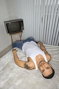 Bored Young Man Lying on Bed