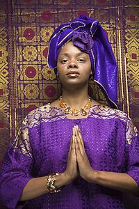 Young Woman Praying and Wearing Traditional African Dress