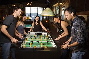 Group of People Playing Foosball