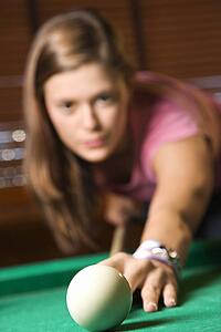 Young Woman Playing Billiards