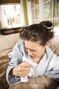 Young Sick Woman Sneezing