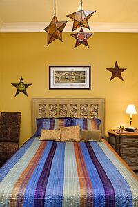 Bedroom Interior With Striped Bedspread and Decorative Stars