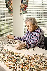 Elderly Woman Doing Jig Saw Puzzle