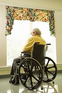 Elderly Man in Wheelchair by Window