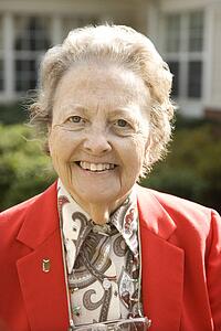 Elderly Woman in Red Coat Outdoors Smiling