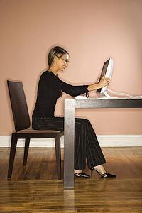 Young Businesswoman Looking at Computer Surprised