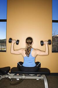 Woman Seated Lifting Weights