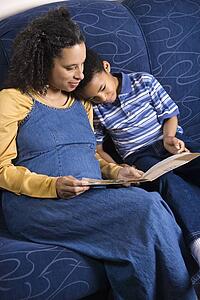 Mother Reading Book to Son