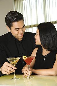 Attractive Young Couple With Cocktails Smiling