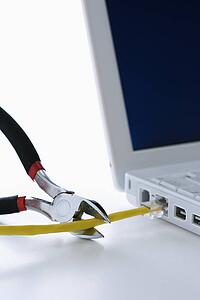 Wire Cutters Cutting Cable to Laptop