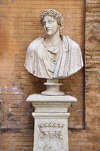 Carved Bust In Front of Brick Wall