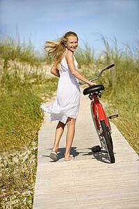 Girl Walking Bike on Boardwalk