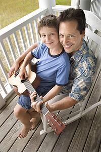 Father and Son on Porch Playing Guitar