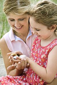 Mother and Daughter Looking at Shells