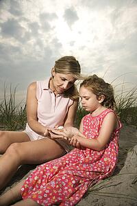 Mother and Daughter Looking at Shells