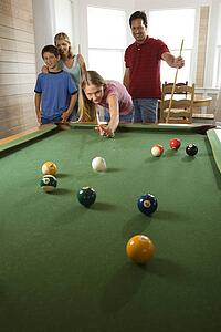 Family Playing Pool in Rec Room