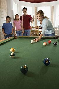 Family Playing Pool in Rec Room