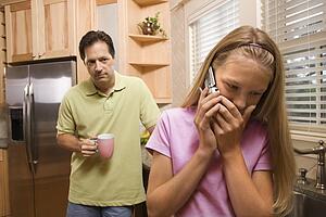 Father watching Daughter on phone