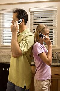 Man and Young Girl on Phones