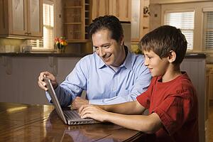 Man and Young Boy on Laptop